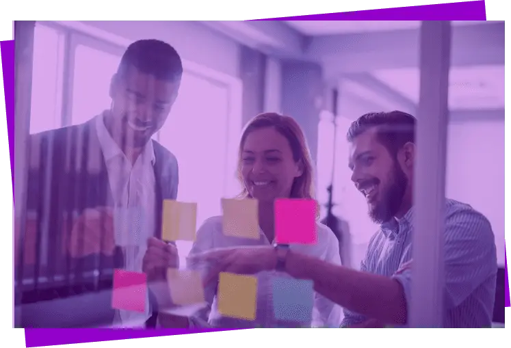 Imagem com filtro roxo de dois homens e uma mulher entre eles, todos apontando e sorrindo para notas adesivas coloridas.